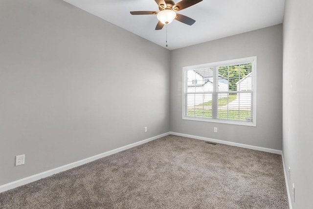 empty room featuring carpet flooring and ceiling fan