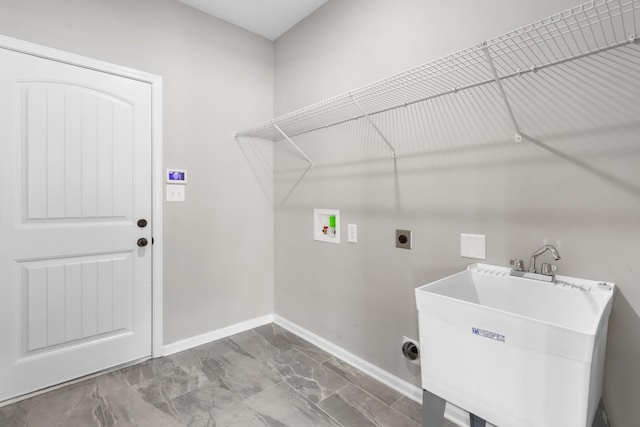 laundry room with hookup for an electric dryer, hookup for a washing machine, and sink