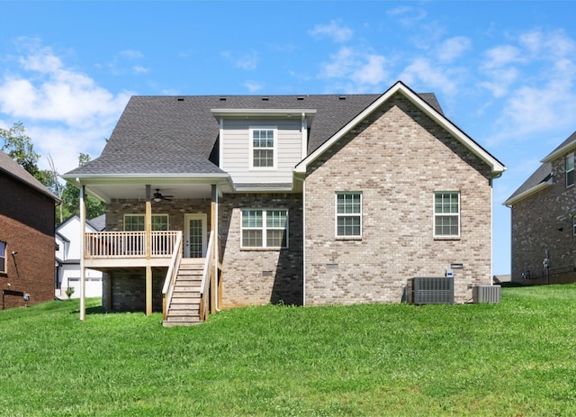 back of property with ceiling fan, a yard, and cooling unit