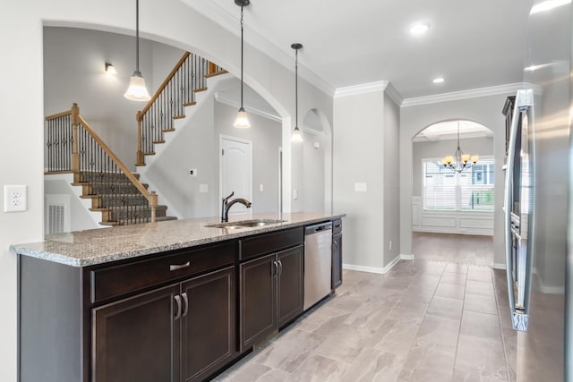 kitchen with decorative light fixtures, stainless steel appliances, an inviting chandelier, and sink