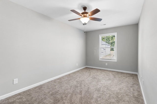 carpeted spare room with ceiling fan