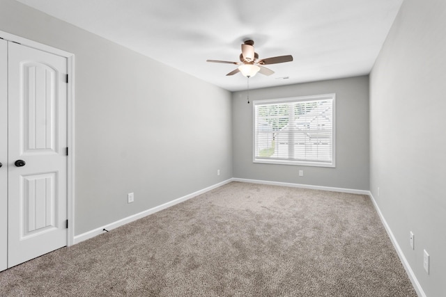 spare room with carpet flooring and ceiling fan