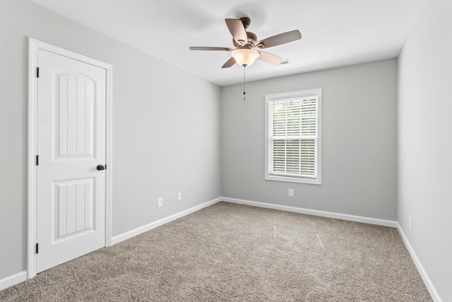 spare room featuring ceiling fan and carpet floors