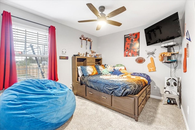 bedroom featuring light colored carpet and ceiling fan