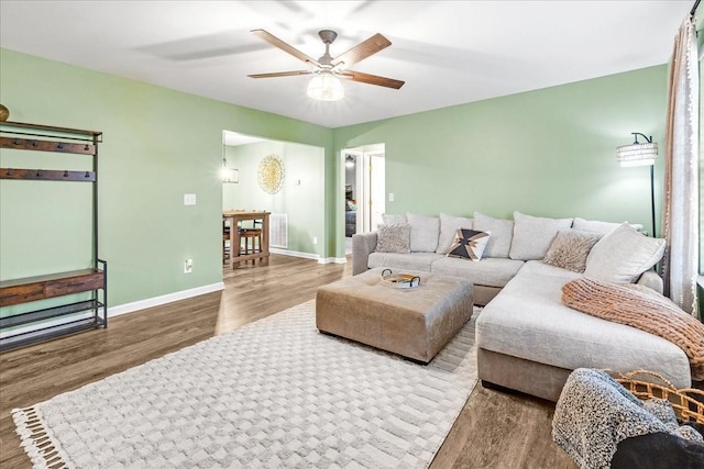 living room with ceiling fan and hardwood / wood-style floors