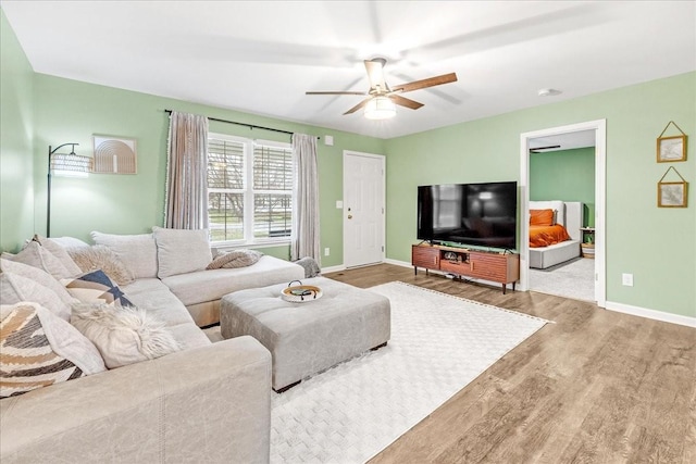 living room with wood-type flooring and ceiling fan