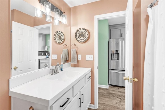 bathroom with hardwood / wood-style floors and vanity