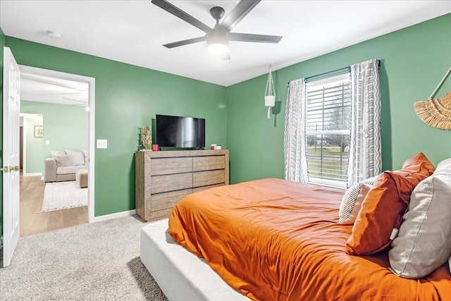 bedroom with ceiling fan and light colored carpet