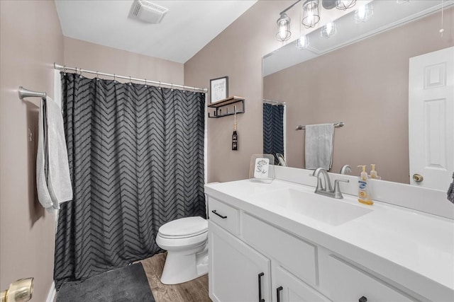 bathroom featuring walk in shower, vanity, wood-type flooring, toilet, and lofted ceiling