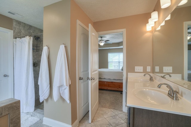 bathroom featuring vanity, tile patterned floors, a shower with curtain, ceiling fan, and a textured ceiling