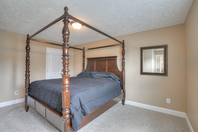 bedroom featuring carpet flooring and a textured ceiling