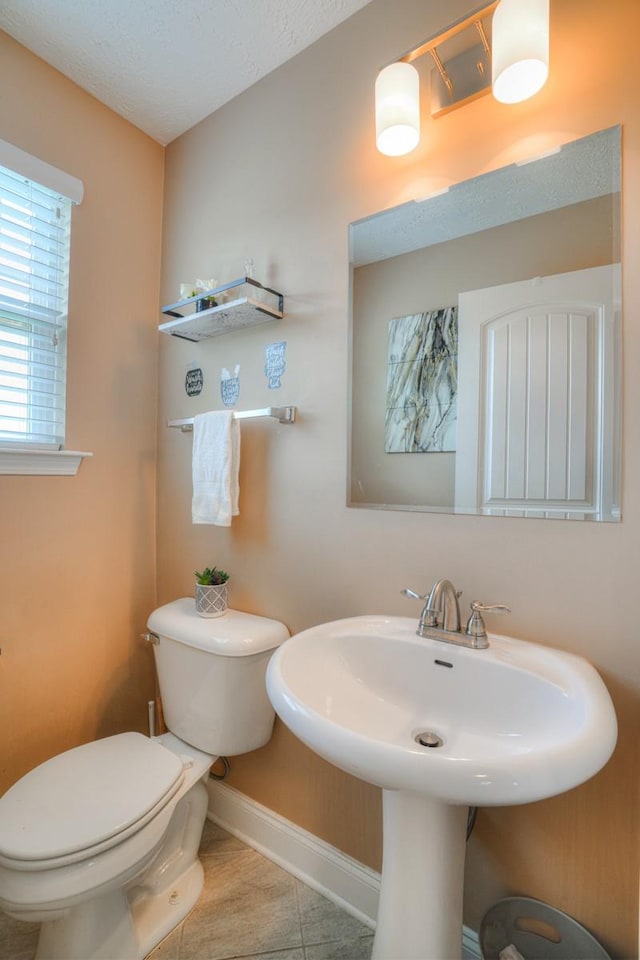 bathroom featuring tile patterned floors and toilet