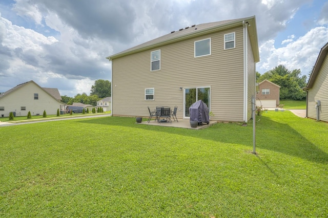 back of property featuring a patio area and a yard