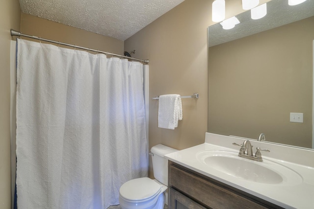 bathroom with vanity, curtained shower, toilet, and a textured ceiling