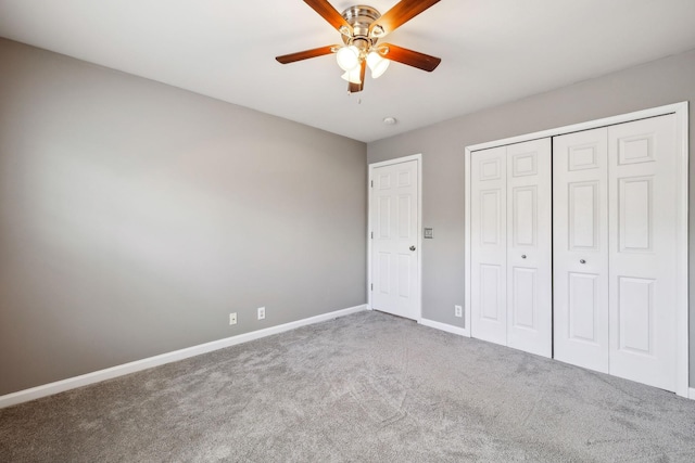 unfurnished bedroom with a closet, ceiling fan, and carpet flooring