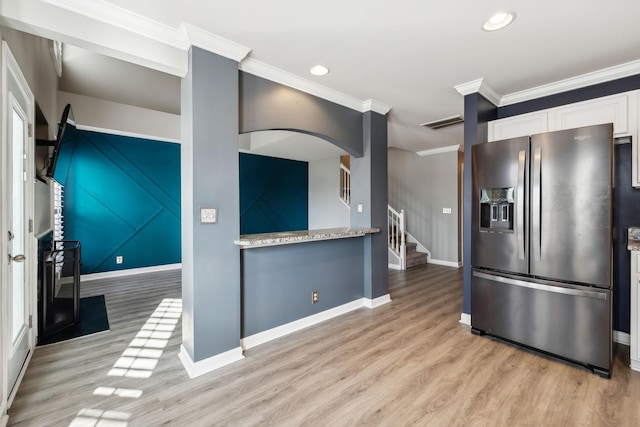 kitchen with white cabinetry, stainless steel refrigerator with ice dispenser, ornamental molding, and light hardwood / wood-style flooring