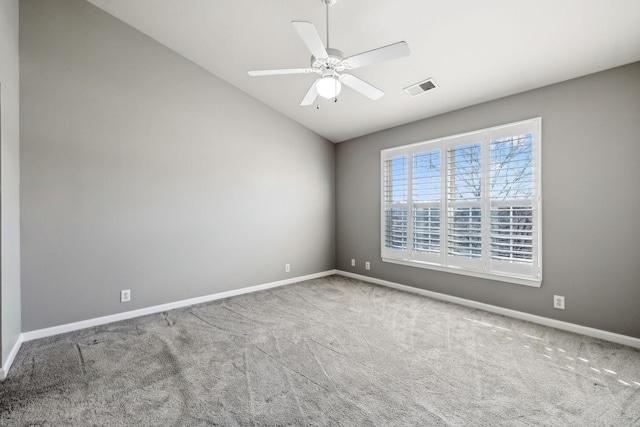 carpeted empty room featuring vaulted ceiling and ceiling fan