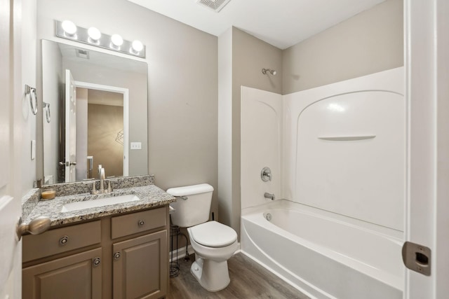 full bathroom with vanity, shower / washtub combination, hardwood / wood-style floors, and toilet