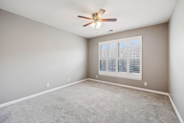 spare room featuring ceiling fan and carpet