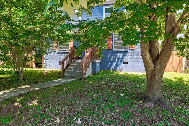 obstructed view of property with a front lawn