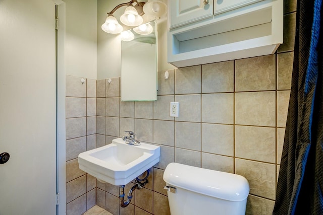 bathroom featuring toilet and tile walls