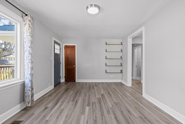 empty room with a healthy amount of sunlight and light wood-type flooring