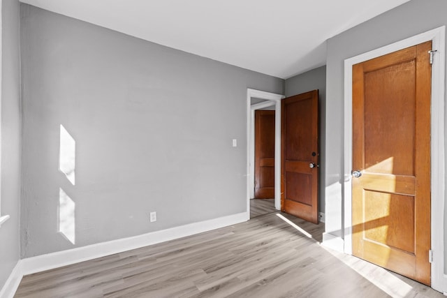 empty room with light hardwood / wood-style floors