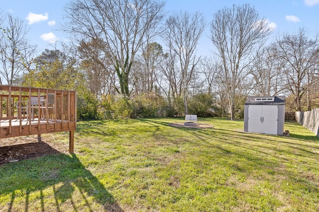 view of yard with a storage shed and a deck