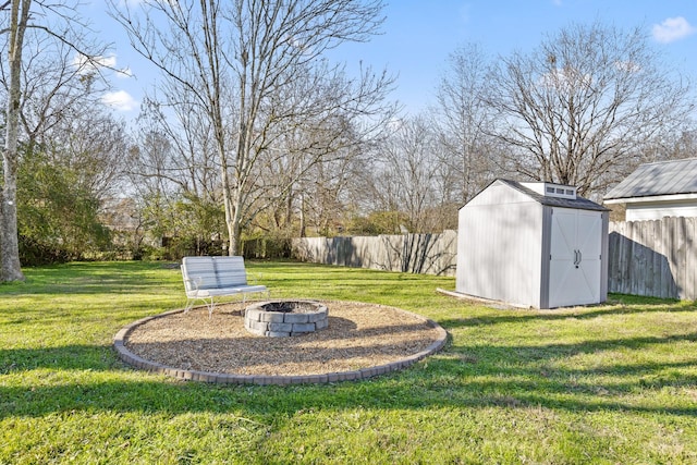 view of yard with a storage unit and an outdoor fire pit