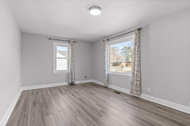 spare room with light hardwood / wood-style flooring