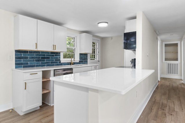 kitchen featuring sink, range, stainless steel dishwasher, white cabinets, and light wood-type flooring