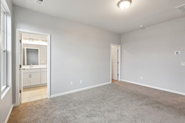 carpeted empty room with sink