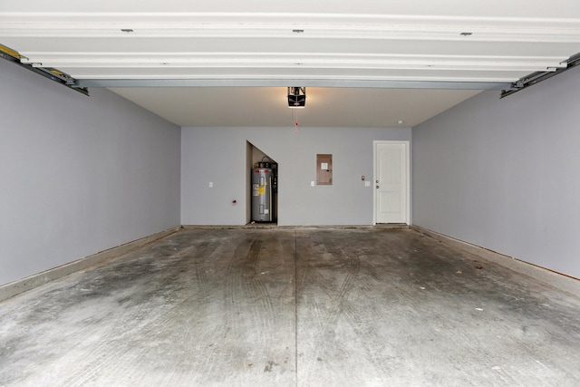 garage featuring electric panel, electric water heater, and a garage door opener