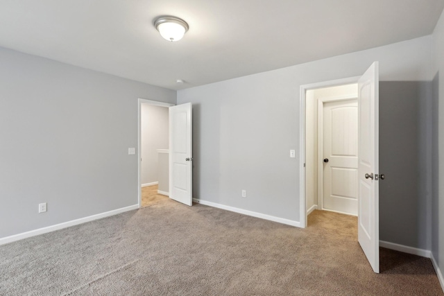 unfurnished bedroom with light colored carpet