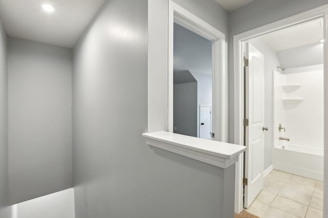 hall with light tile patterned floors