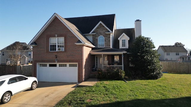 front of property featuring covered porch, a front yard, and a garage