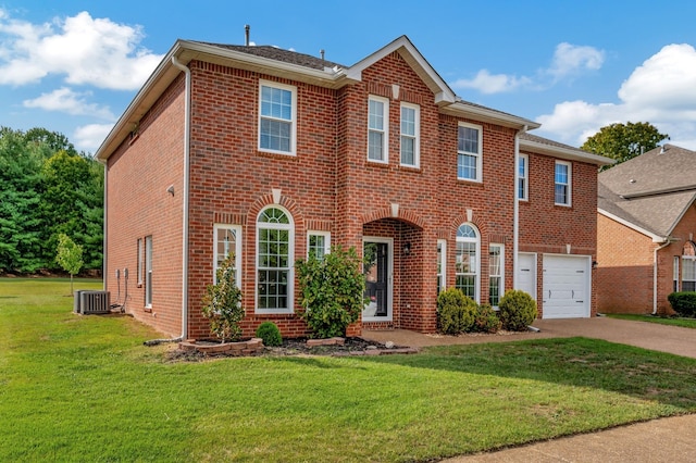 view of front facade with central AC, a garage, and a front lawn