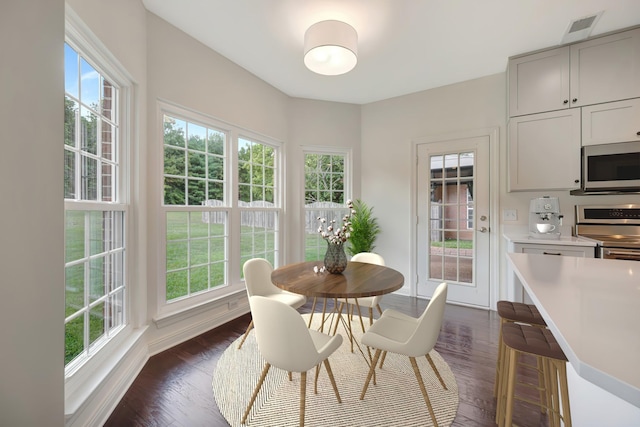 dining space with dark wood-type flooring