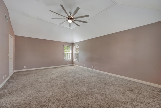 carpeted empty room with ceiling fan and high vaulted ceiling