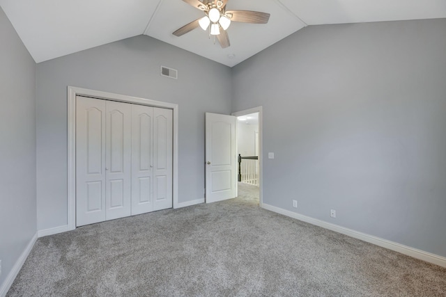 unfurnished bedroom featuring ceiling fan, light carpet, high vaulted ceiling, and a closet