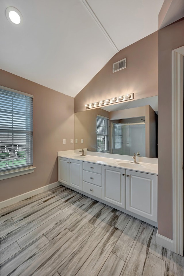 bathroom with vanity and lofted ceiling