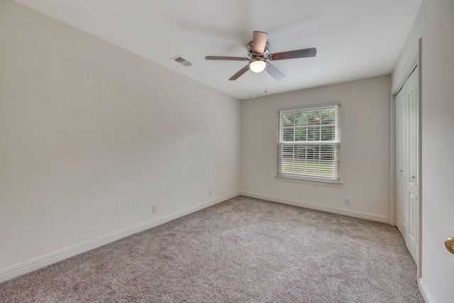 interior space featuring a closet, ceiling fan, and light colored carpet