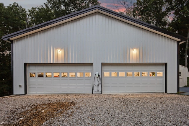 view of garage at dusk