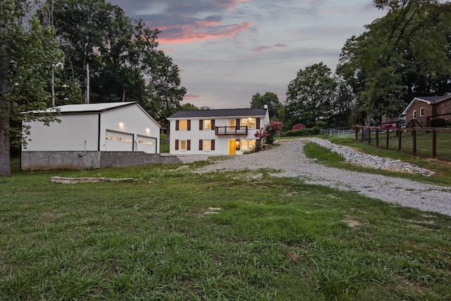 exterior space with a garage, an outdoor structure, and a yard