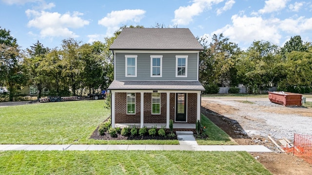 front facade featuring a front yard and covered porch