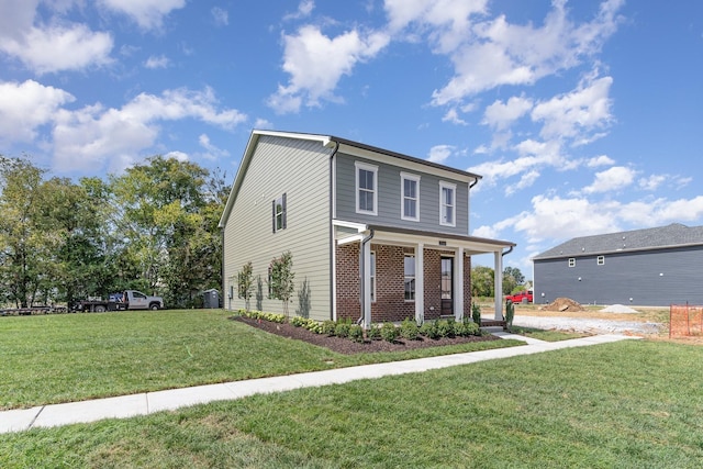 view of front of house with covered porch and a front yard