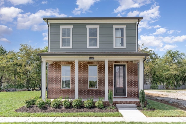 view of front property featuring covered porch and a front yard