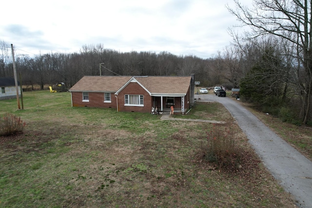 view of front of home with a porch and a front yard