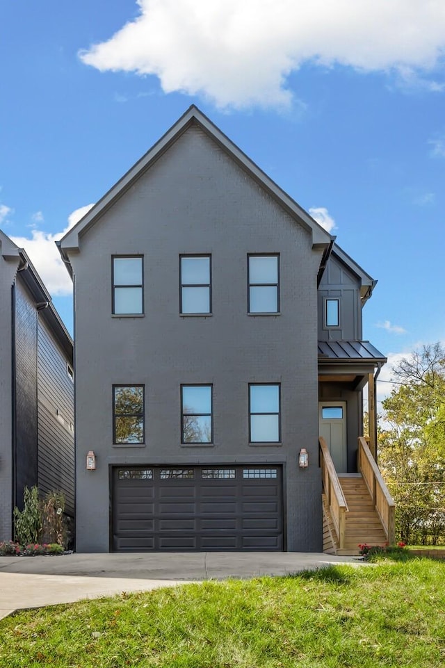 view of front of property featuring a garage and a front lawn