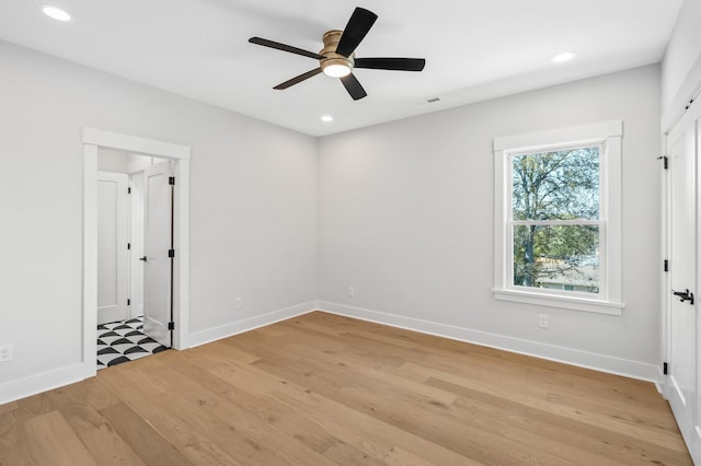 unfurnished room with ceiling fan and light hardwood / wood-style floors